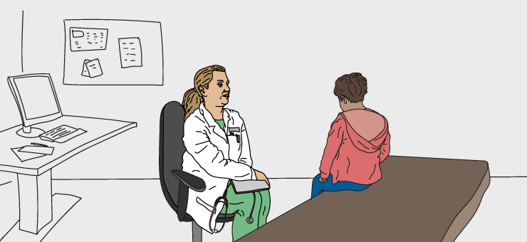 En läkare sitter i samtal med ett barn på läkarmottagning.