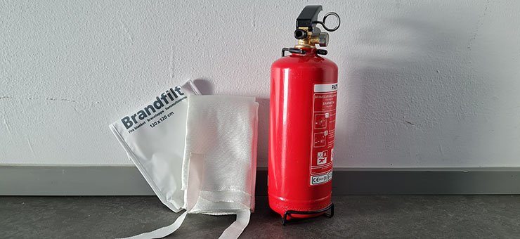 A red fire extinguisher and a fire blanket.