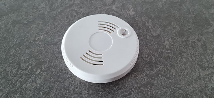 A white smoke detector.