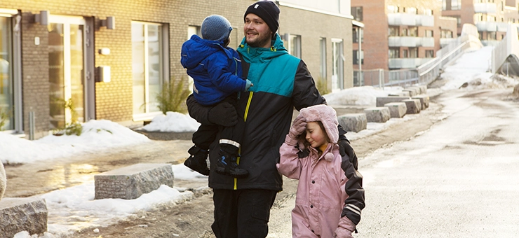 A father out walking with his two children.